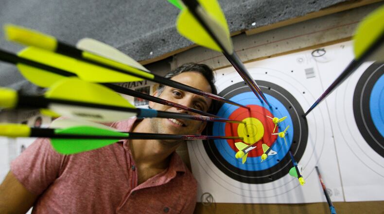 Carlos Frias shows off his bullseye at the indoor range at Palm Beach Archery in west Boca Raton.