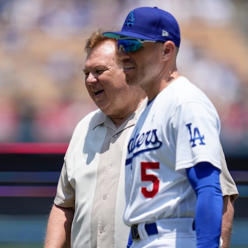 FILE - Los Angeles Dodgers first baseman Freddie Freeman (5) on the field walks with his father, Fred Freeman, before a baseball game against the San Francisco Giants in Los Angeles, Sunday, June 18, 2023. (AP Photo/Ashley Landis, File)