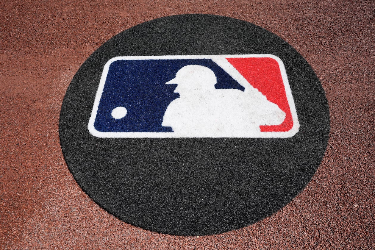 FILE - THe Major League Baseball logo is seen on the field before a spring training baseball game between the Pittsburgh Pirates and the Atlanta Braves Tuesday, Feb. 27, 2024, in Bradenton, Fla. (AP Photo/Charlie Neibergall, File)
