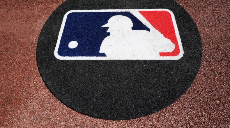 FILE - THe Major League Baseball logo is seen on the field before a spring training baseball game between the Pittsburgh Pirates and the Atlanta Braves Tuesday, Feb. 27, 2024, in Bradenton, Fla. (AP Photo/Charlie Neibergall, File)