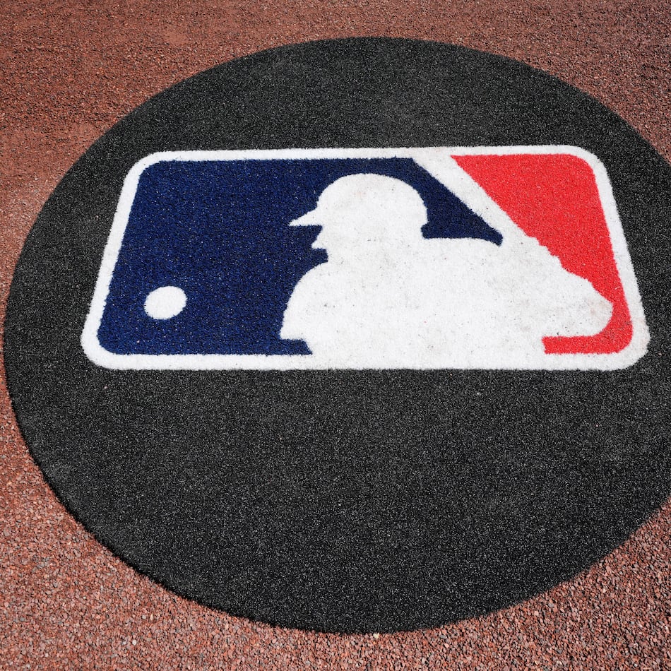 FILE - THe Major League Baseball logo is seen on the field before a spring training baseball game between the Pittsburgh Pirates and the Atlanta Braves Tuesday, Feb. 27, 2024, in Bradenton, Fla. (AP Photo/Charlie Neibergall, File)