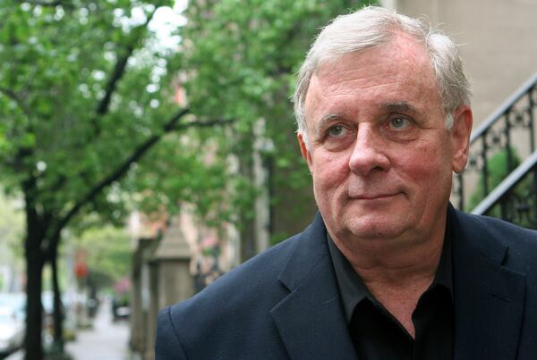 FILE - Author Edmund White stands outside his apartment April 24, 2006 in New York. (AP Photo/Mark Lennihan, file)