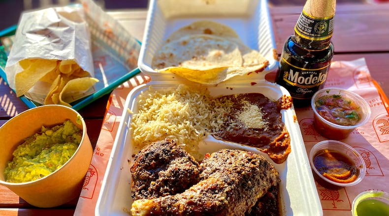 Pollo Supremo’s meals come with beans, rice, tortillas, pico de gallo and red and green salsa. This is the half-bird meal, plus guacamole and chips. Wendell Brock for The Atlanta Journal-Constitution