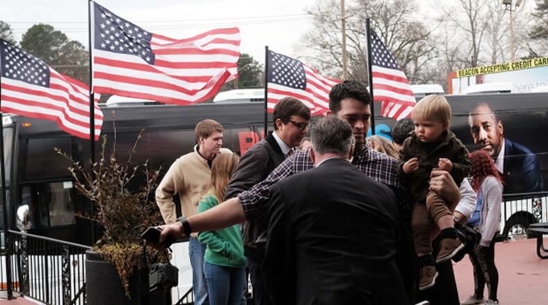 People are searched by the Secret Service as Republican presidential candidate Ben Carson visits voters in a restaurant during the Republican presidential primary on February 20, 2016 in Spartanburg, South Carolina. Polls show New York businessman Donald Trump leading his closest rival U.S. Sen. Ted Cruz (R-TX). (Photo by Spencer Platt/Getty Images)