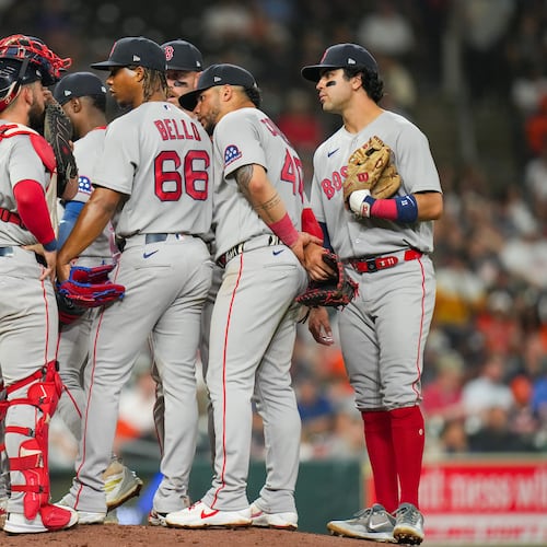 Boston Red Sox starting pitcher Brayan Bello (66) talks with teammates during a mound visit in the fifth inning of a baseball game against the Houston Astros in Houston, Tuesday, March 31, 2026. (AP Photo/Jon Shapley)