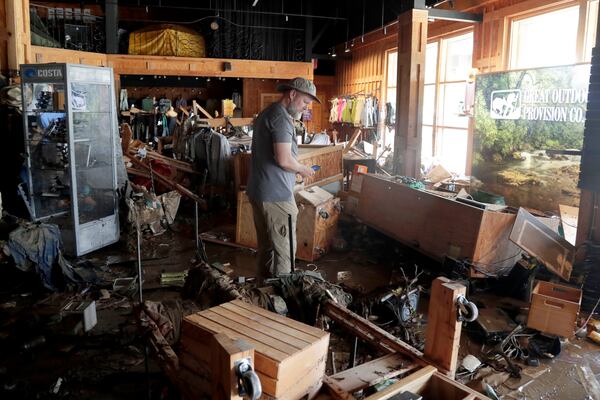 An employee surveys the damage at the Great Outdoor Provision Co. after it was flooded during tropical storm Chantal, Monday, July 7, 2025, in Chapel Hill, N.C. (AP Photo/Chris Seward)