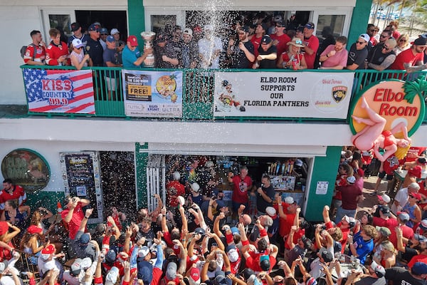 Members of the Florida Panthers hockey team celebrate with fans outside the Elbo Room, Wednesday, June 18, 2025, in Fort Lauderdale, Fla., the morning after defeating Edmonton in Game 6 of the Stanley Cup Final. (Amy Beth Bennett/South Florida Sun-Sentinel via AP)
