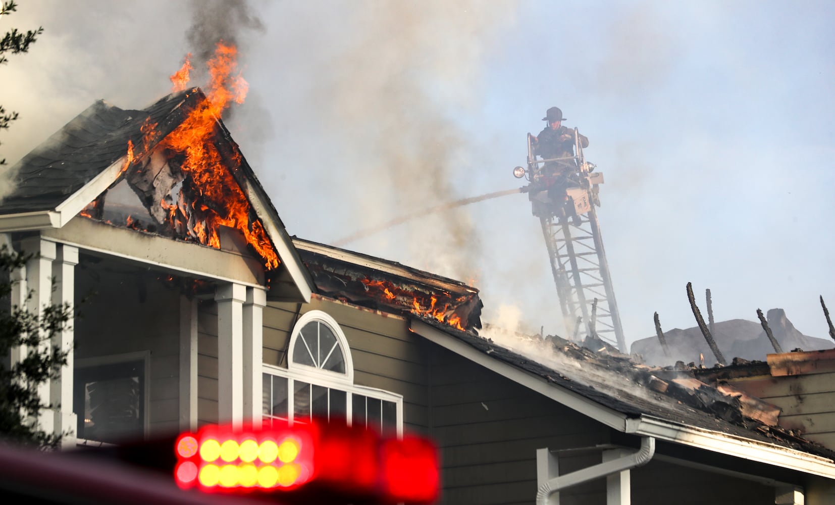 July 18, 2022 DeKalb County: All residents of a Brookhaven apartment building were able to escape their homes safely when a massive blaze broke out early Monday morning, July 18, 2022. No injuries were reported in the fire at the Evergreen Lenox Park apartments, which sent huge flames and smoke high into the air above nearby Roxboro and North Druid Hills roads at the start of the morning commute. Everyone inside the building evacuated before the first crews arrived about 6:30 a.m., thanks in large part to the effort of one man. Yusuf Thorne was on his way into work when he heard a subtle cracking sound and spotted the fire coming from an apartment on the third floor. Thorne said he called 911, connected with a dispatcher, and immediately hung up to begin knocking on his neighborsÕ doors. He escorted one woman to safety and went back again to try to wake another neighbor. ÒHe eventually came out,Ó Thorne said. ÒI was going to have to kick the door down if they didnÕt get out of there.Ó Thorne said he had to continue knocking on doors as the fire spread. According to fire Capt. Jaeson Daniels, the flames reached an attic space and eventually destroyed several third-floor units. ÒIt started on the third floor so the fire didnÕt have very far to travel to get to the attic, really saving the apartments on the bottom from fire damage,Ó Daniels said. ÒBut unfortunately, the top apartments had severe fire damage.Ó He estimates about 18 families will lose their homes and need the assistance of the American Red Cross for temporary lodging and other emergency needs. Fire crews dug through the debris Monday morning to learn the extent of the damage. Investigators have not determined the fireÕs cause or exact origin. (John Spink / John.Spink@ajc.com)

