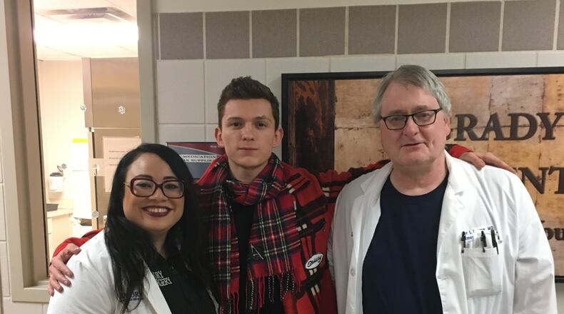 Tom Holland with Dr. Rachel Williams and Dr. Walter Ingram at Grady Memorial Hospital. Photos provided to the AJC by Allied Integrated Marketing and used with permission.