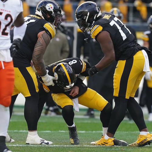 Pittsburgh Steelers quarterback Aaron Rodgers (8) is helped up off the field after a hit by the Cincinnati Bengals during the first half of an NFL football game Sunday, Nov. 16, 2025, in Pittsburgh. (AP Photo/Matt Freed)