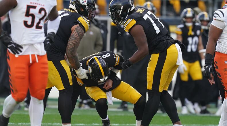 Pittsburgh Steelers quarterback Aaron Rodgers (8) is helped up off the field after a hit by the Cincinnati Bengals during the first half of an NFL football game Sunday, Nov. 16, 2025, in Pittsburgh. (AP Photo/Matt Freed)