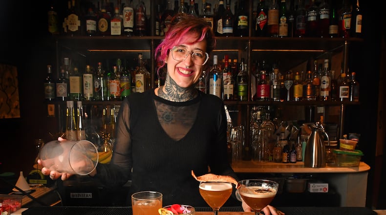 Flemming Love, mixologist at Southern Belle and Georgia Boy, performs the final stage, a smoke dome, on a nonalcoholic cocktail called Modern Yesterdays (left); also shown: At Dusk or Dawn, Southern Sentiments, and Dear Diary (far right). (Styling by Flemming Love / Chris Hunt for the AJC)