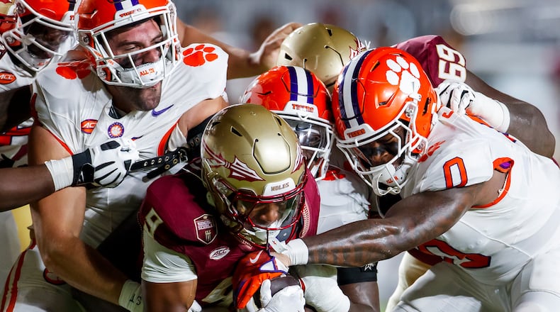 Florida State running back Lawrance Toafili (9) is grabbed by a group of Clemson defenders including linebacker Barrett Carter (0) during the first half of an NCAA college football game in 2024, in Tallahassee, Florida. (Colin Hackley/AP Photo)