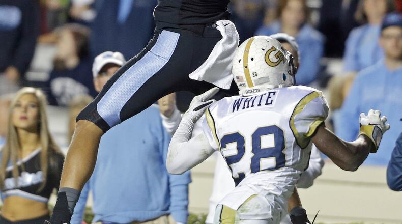 North Carolina's Mack Hollins (13) catches a touchdown pass as Georgia Tech's D.J. White (28) defends during the second half of an NCAA college football game in Chapel Hill, N.C., Saturday, Oct. 18, 2014. North Carolina won 48-43. (AP Photo/Gerry Broome) Georgia Tech's defense allowed too many plays like this one: a 36-yard touchdown pass to Mack Hollins in the fourth quarter. (AP photo)