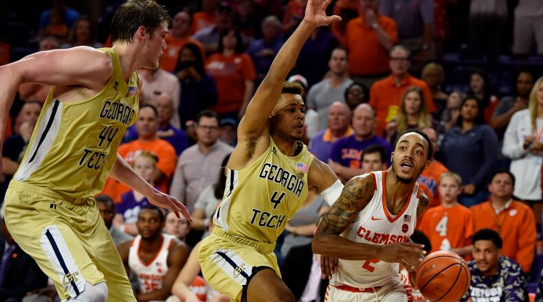 Clemson's Marcquise Reed, right, drives to the basket while defended by Georgia Tech's Brandon Alston, center, and Ben Lammers during the second half of an NCAA college basketball game Saturday, Feb. 24, 2018, in Clemson, S.C. (AP Photo/Richard Shiro)