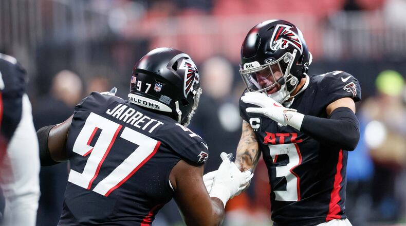 Atlanta Falcons safety Jessie Bates III (3) and Atlanta Falcons defensive end Grady Jarrett (97) shake hands as they work out during a warm-up session before the game against the Caroline Panthers on Sunday, January 5, 2025, at Mercedes-Benz Stadium in Atlanta. 
(Miguel Martinez/ AJC)