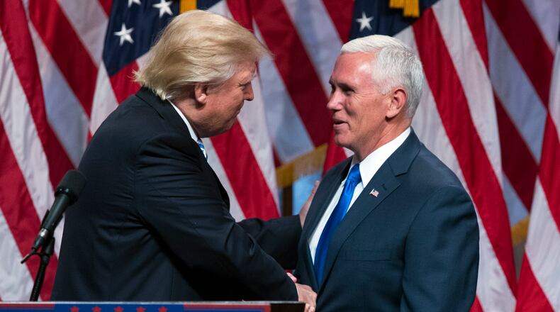 Republican presidential candidate Donald Trump, left, shakes hands with Gov. Mike Pence, R-Ind., during a campaign event to announce Pence as the vice presidential running mate on Saturday in New York. AP/Evan Vucci