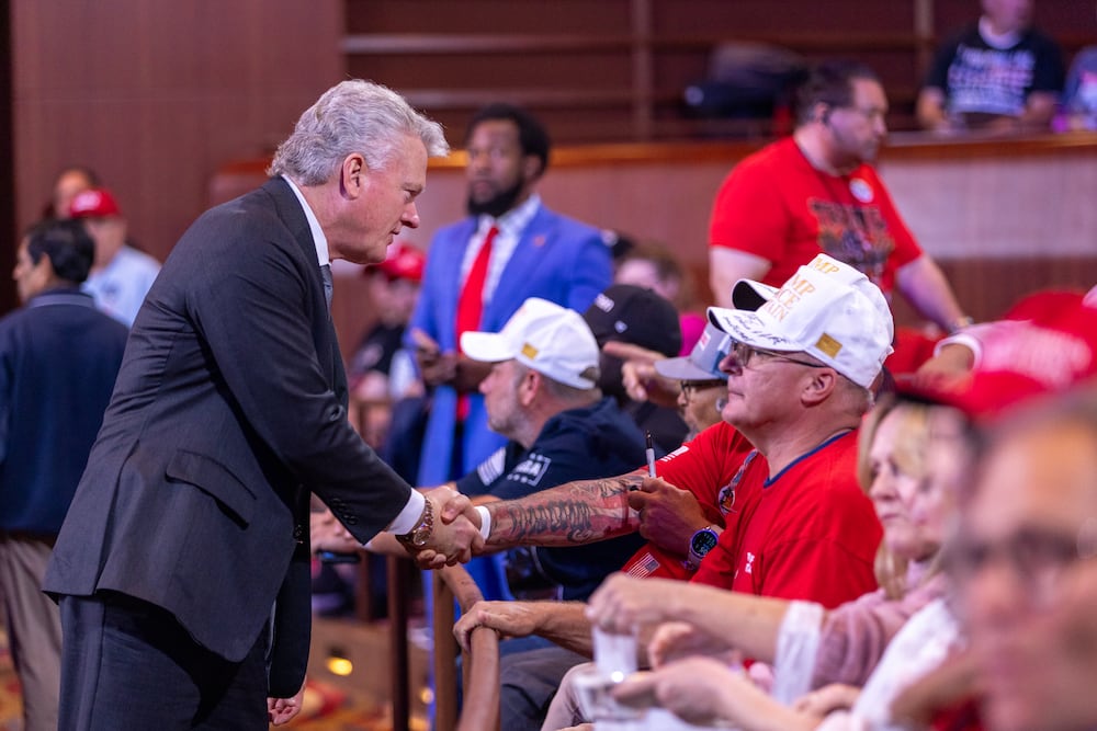 U.S. Rep. Mike Collins, R-Jackson, greeted an attendee at a Donald Trump rally in Atlanta last August.