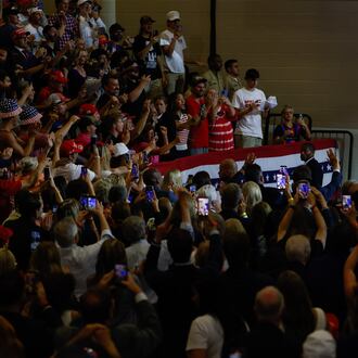 President Donald Trump points to the crowd after speaking at Wheeler High School in Marietta on Wednesday. (Arvin Temkar/AJC)