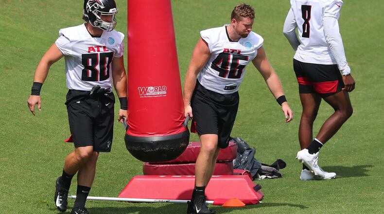 Falcons tight ends Ryan Becker (from left), Parker Hesse and Kyle Pitts take the field for some drills during team practice at minicamp Wednesday, June 10, 2021, in Flowery Branch. (Curtis Compton / Curtis.Compton@ajc.com)