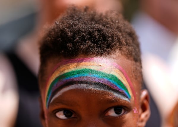 A child watches the World Pride parade, Saturday, June 7, 2025, in Washington. (AP Photo/Julia Demaree Nikhinson)