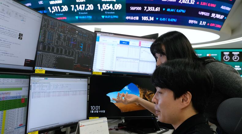 Currency traders watch monitors at the foreign exchange dealing room of the Hana Bank headquarters in Seoul, South Korea, Wednesday, May 20, 2026. (AP Photo/Ahn Young-joon)