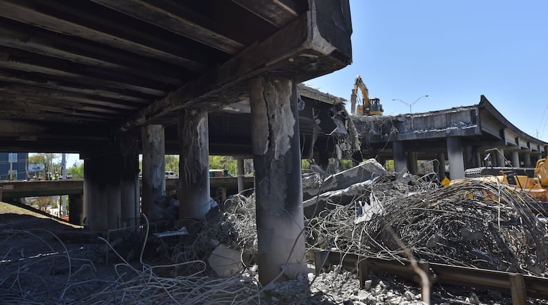 Crews demolish a damaged section of I-85 bridge structures on Saturday, April 1, 2017. Necessary work is continuing on the damaged sections of I-85 bridge structures. This includes demolition of the existing failed and damaged structures - which includes two 350-foot sections of interstate, one section each in both the northbound and southbound lanes, totaling approximately 700 feet - as well as all reconstruction activities. HYOSUB SHIN / HSHIN@AJC.COM