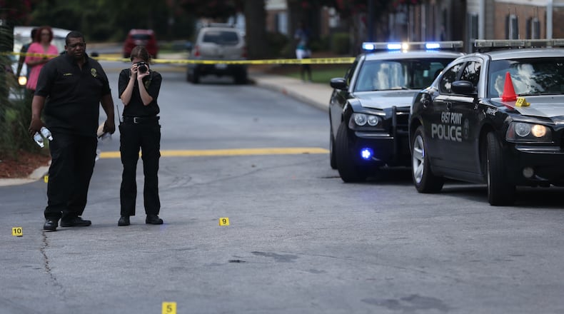 East Point police process the scene of a July 20, 2015, triple shooting that left two teenagers wounded and another dead. BEN GRAY / BGRAY@AJC.COM