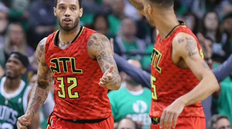 Hawks’ Mike Scott (left) gets five from Thabo Sefolosha after getting a defensive turn over against Celtics’ Isaiah Thomas during the third period in Game 6 of an NBA basketball first-round playoff series at TD Garden on Thursday, April 28, 2016, in Boston. Curtis Compton / ccompton@ajc.com