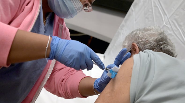 A woman is administered a dose of COVID-19 vaccine in 2021. (PHOTO by Anthony Behar/Sipa USA/TNS)