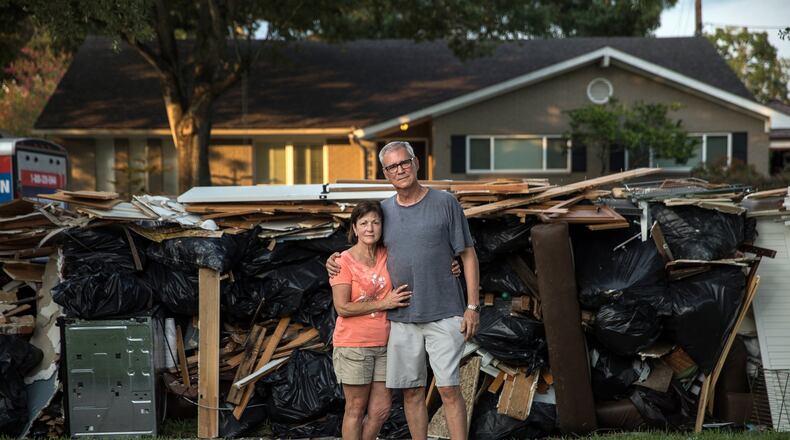 John Walton, 68, and Michele Walton, 61, outside of their flood-damaged home in Houston. Amid the storm devastation, some people in Texas found ways to save treasured personal items. (Tamir Kalifa/The New York Times)