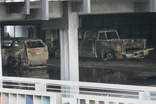 Burned vehicles are seen inside a garage that caught fire and a floor of the structure collapsed Tuesday, June 10, 2025, in Nashville, Tenn. (AP Photo/George Walker IV)