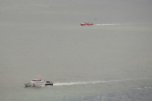 Indonesian Coast Guard and National Search and Rescue Agency ship cruise the waters of Bali Strait during a search operation for the victims of a late Wednesday ferry sinking near Bali, Indonesia, Friday, July 4, 2025. (AP Photo/Firdia Lisnawati)