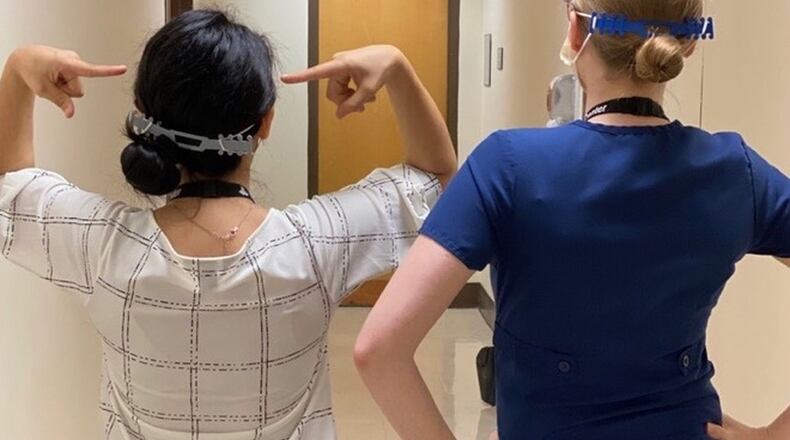 Medical workers at Northeast Georgia Health System in Gainesville show how a plastic accessory created by manufacturing students at Maxwell High School of Technology in Gwinnett County makes the facial shields that are part of their personal protection equipment fit better and feel more comfortable. COURTESY OF NORTHEAST GEORGIA HEALTH SYSTEM
