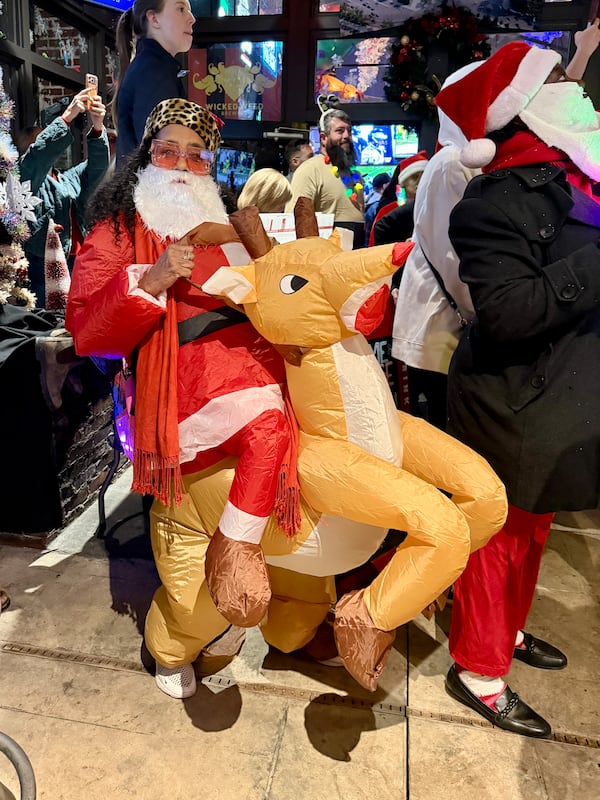 Rhonda Dinwiddie Hagler, 63 from Lithonia, GA, was a SantaCon first-timer this year. She came with three cousins and siblings and wore a blow-up costume of Santa riding Ruldolph.