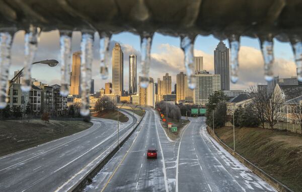 Friday’s ice storm, which left this icy coating over a railing at Freedom Parkway, knocked out power for more than 50,000 Georgia Power customers, mostly in metro Atlanta. JOHN SPINK /JSPINK@AJC.COM