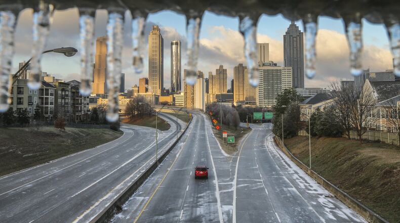 Friday’s ice storm, which left this icy coating over a railing at Freedom Parkway, knocked out power for more than 50,000 Georgia Power customers, mostly in metro Atlanta. JOHN SPINK /JSPINK@AJC.COM