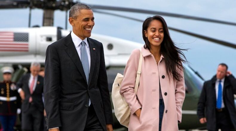 FILE - In a Thursday, April 7, 2016 file photo, President Barack Obama jokes with his daughter Malia Obama as they walk to board Air Force One from the Marine One helicopter, as they leave Chicago en route to Los Angeles. The White House announced Sunday, May 1, 2016, that Malia Obama will take a year off after high school and attend Harvard University in 2017. (AP Photo/Jacquelyn Martin, File)