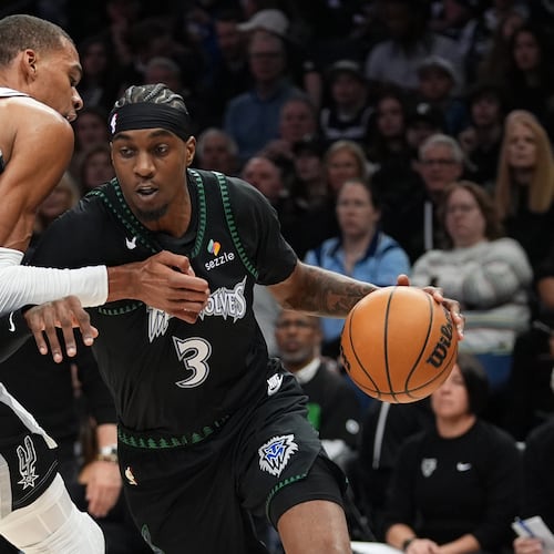 Minnesota Timberwolves forward Jaden McDaniels (3) drives against San Antonio Spurs forward Victor Wembanyama (1) during the first half of Game 3 of a NBA basketball second-round playoff series in Minneapolis, Friday, May 8, 2026. (AP Photo/Abbie Parr)