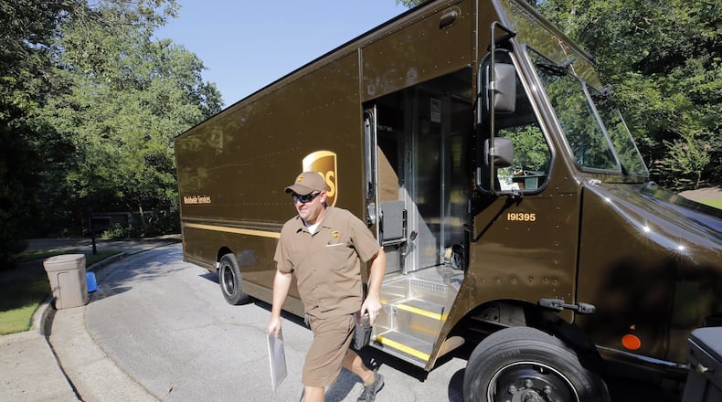 Driver Dan Partyka delivers an overnight package last year. As more people buy more goods online, the rapid and unrelenting expansion of e-commerce is causing real challenges for UPS.  BOB ANDRES /BANDRES@AJC.COM