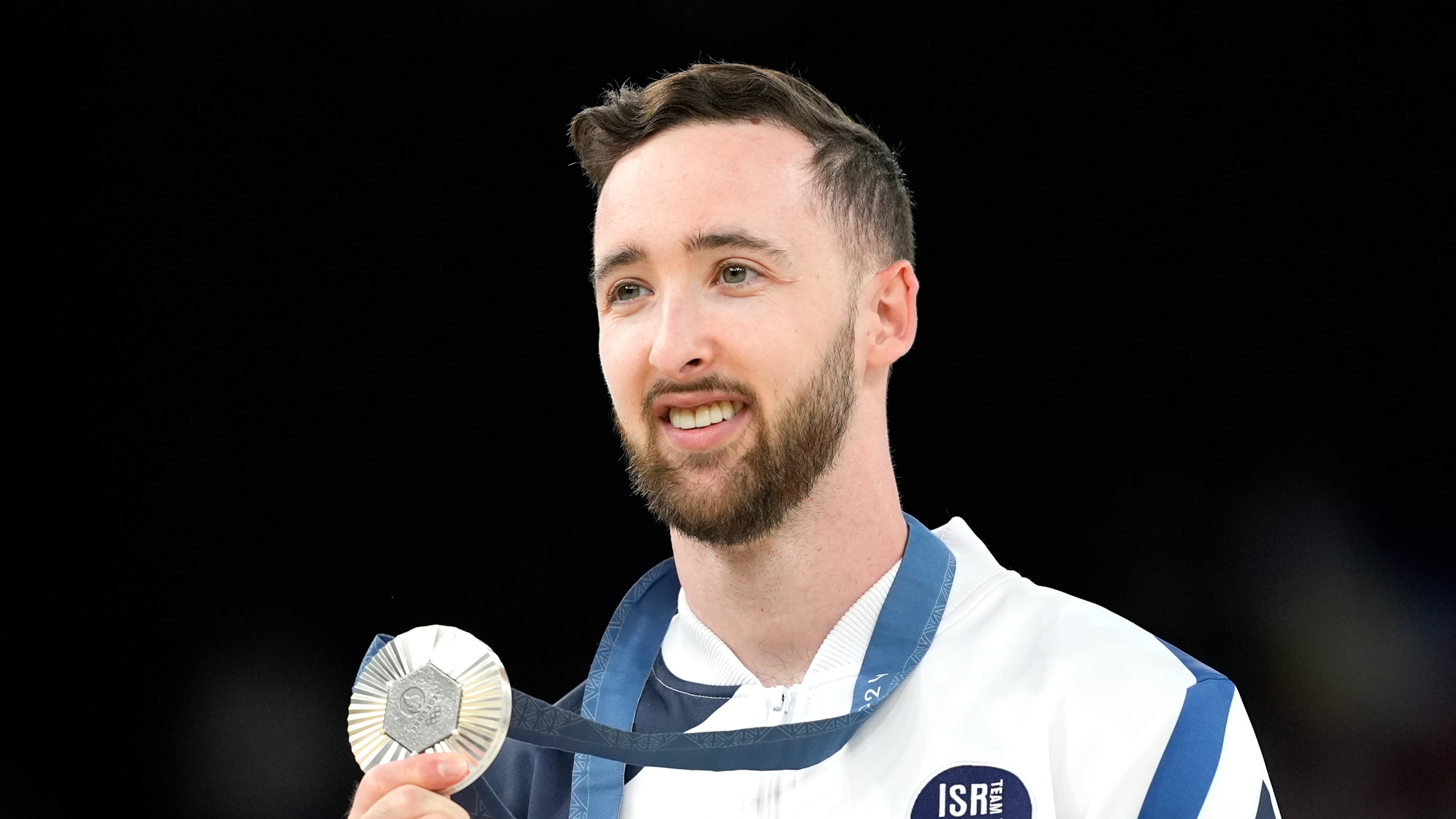 FILE - Artem Dolgopyat of Israel celebrates after winning the silver medal during the men's artistic gymnastics individual floor finals at Bercy Arena at the 2024 Summer Olympics, Saturday, Aug. 3, 2024, in Paris, France. (AP Photo/Francisco Seco, File)