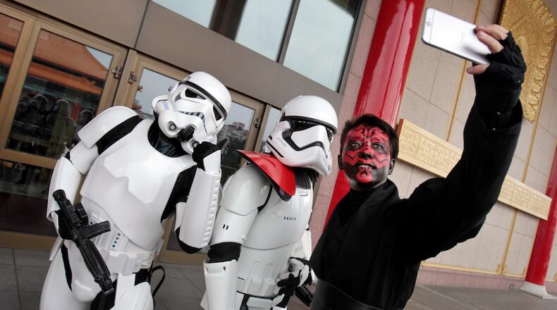 Fans dressed as movie Star Wars characters take photos to cerebrate the Star Wars Day in Taipei, Taiwan, Wednesday, May 4, 2016. May 4 is known as Star Wars Day to fans worldwide since the date is similar to the franchise's slogan, "May the Force Be With You." (AP Photo/Chiang Ying-ying)