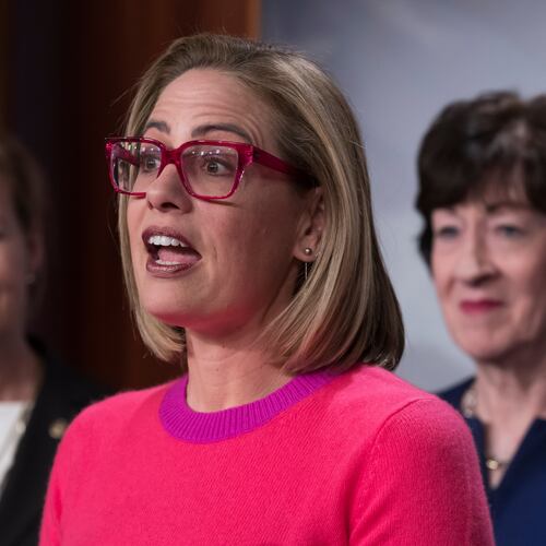 FILE - Sen. Kyrsten Sinema, D-Ariz., flanked by Sen. Tammy Baldwin, D-Wis., left, and Sen. Susan Collins, R-Maine, speaks to reporters following Senate passage of the Respect for Marriage Act, at the Capitol in Washington, Nov. 29, 2022. (AP Photo/J. Scott Applewhite, File)