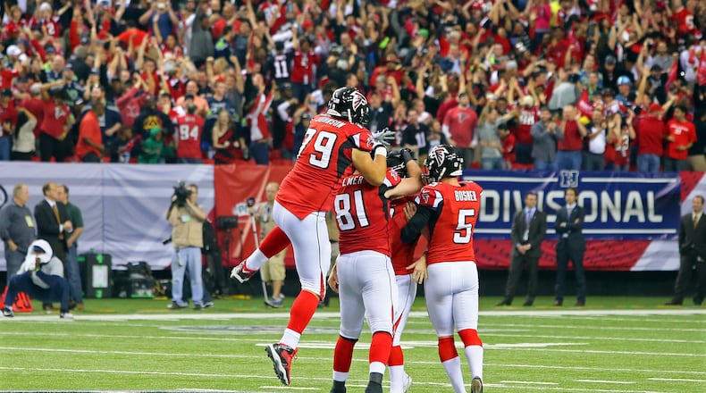 011313 ATLANTA : The crowd goes wild and Falcons players pile on kicker Matt Bryant after his game winning field goal for a 30-28 victory over the Seahawks in their NFL divisional playoff game at the Georgia Dome in Atlanta on Sunday, Jan. 13, 2013. CURTIS COMPTON / CCOMPTON@AJC.COM