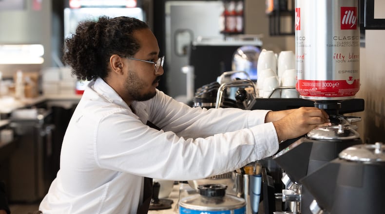 Barista Sanni Mohammed works on getting ready for Thursday's grand opening of Illy Coffee Shop at the Atlantic Station on Tuesday, Nov. 14, 2023. (Steve Schaefer/steve.schaefer@ajc.com).