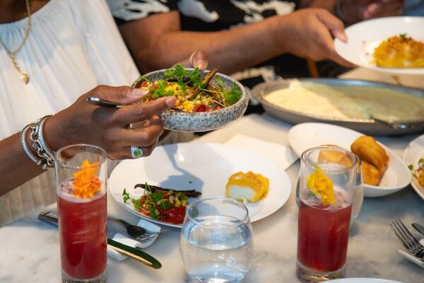 Diners enjoy a family-style dinner and accompanying cocktails during the third Edna Lewis Sunday Supper, held in 2024 at Bread & Butterfly in Atlanta's Inman Park neighborhood.