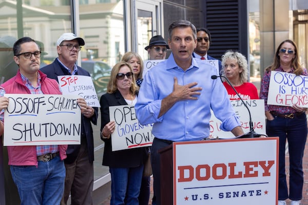Derek Dooley, a Republican running for the U.S. Senate, campaigned outside of incumbent Democratic Sen. Jon Ossoff’s office in Atlanta on Monday.