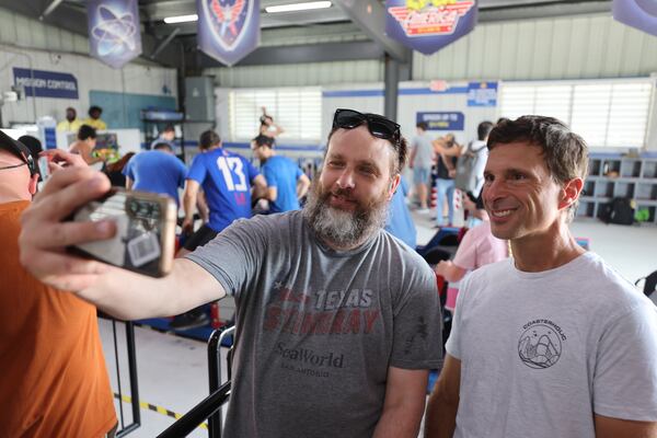 Super-rider James Fordham (right) poses for a selfie with roller coaster enthusiast Oliver Kell, who traveled from Vancouver, Canada, to ride the coaster at Fun Spot America Atlanta in Fayetteville on Thursday, July 30, 2026. (Arvin Temkar/AJC)