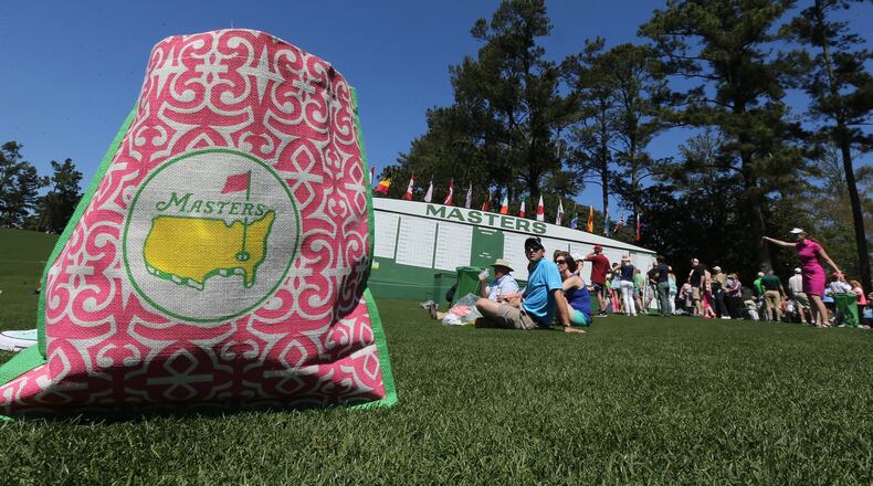 Fans relax and watch the practice rounds along the first fairway at Augusta National Golf Club on Sunday, April 2, 2017, in Augusta. Curtis Compton/ccompton@ajc.com