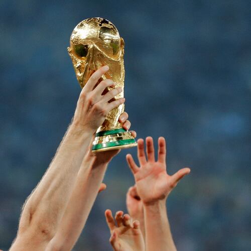 FILE - German players reach out to touch the trophy after the World Cup final soccer match between Germany and Argentina, in Rio de Janeiro, Brasil, July 13, 2014. (AP Photo/Matthias Schrader, File)